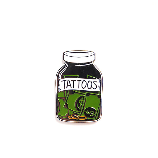 Enamel Pin of a Money Jar and the label Tattoo - alternative punk style accessories for jacket 